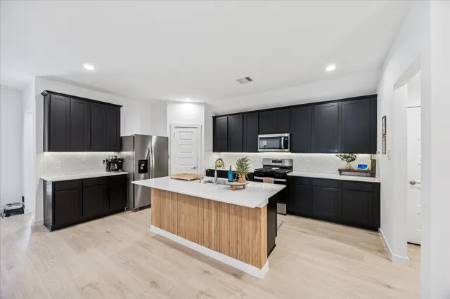 a kitchen with a sink and cabinets