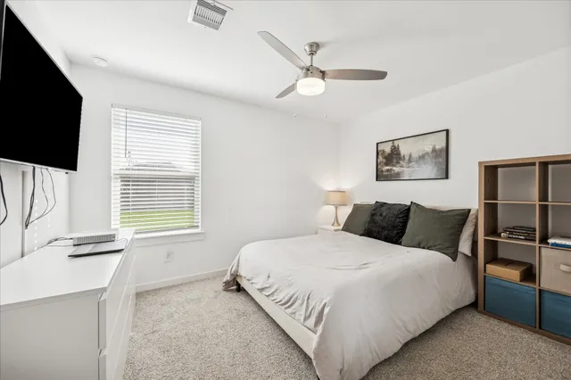 a bedroom with a bed and a flat screen tv
