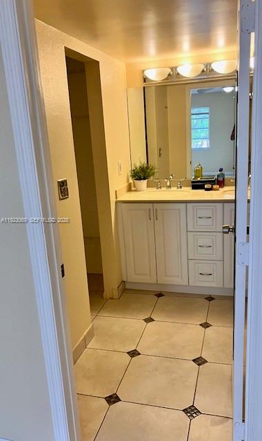 3910 Inverrary Boulevard, Unit 304B Lauderhill, FL 33319 - Photo 11 of 17 a bathroom with a double vanity sink and mirror