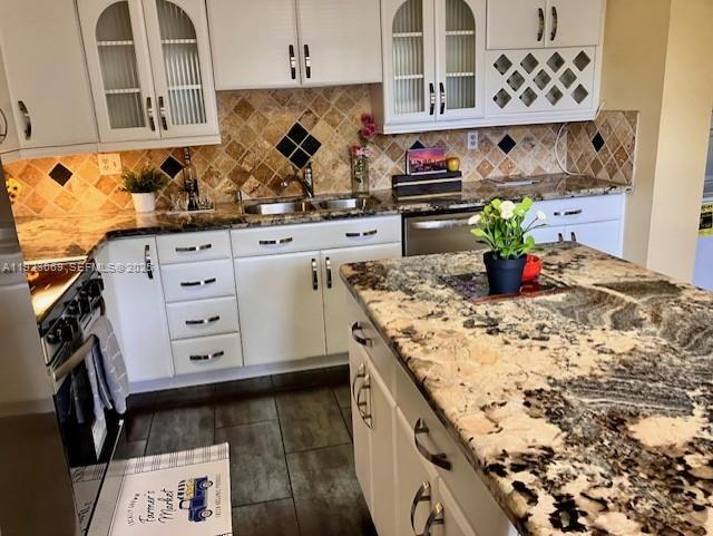 3910 Inverrary Boulevard, Unit 304B Lauderhill, FL 33319 - Photo 17 of 22 a kitchen with stainless steel appliances granite countertop a sink and cabinets