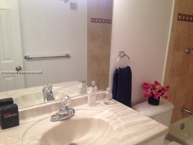 3910 Inverrary Boulevard, Unit 304B Lauderhill, FL 33319 - Photo 3 of 22 a bathroom with a sink vanity and mirror