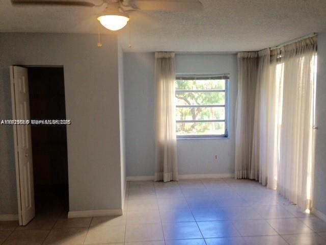 3910 Inverrary Boulevard, Unit 304B Lauderhill, FL 33319 - Photo 7 of 17 an empty room with windows and closet