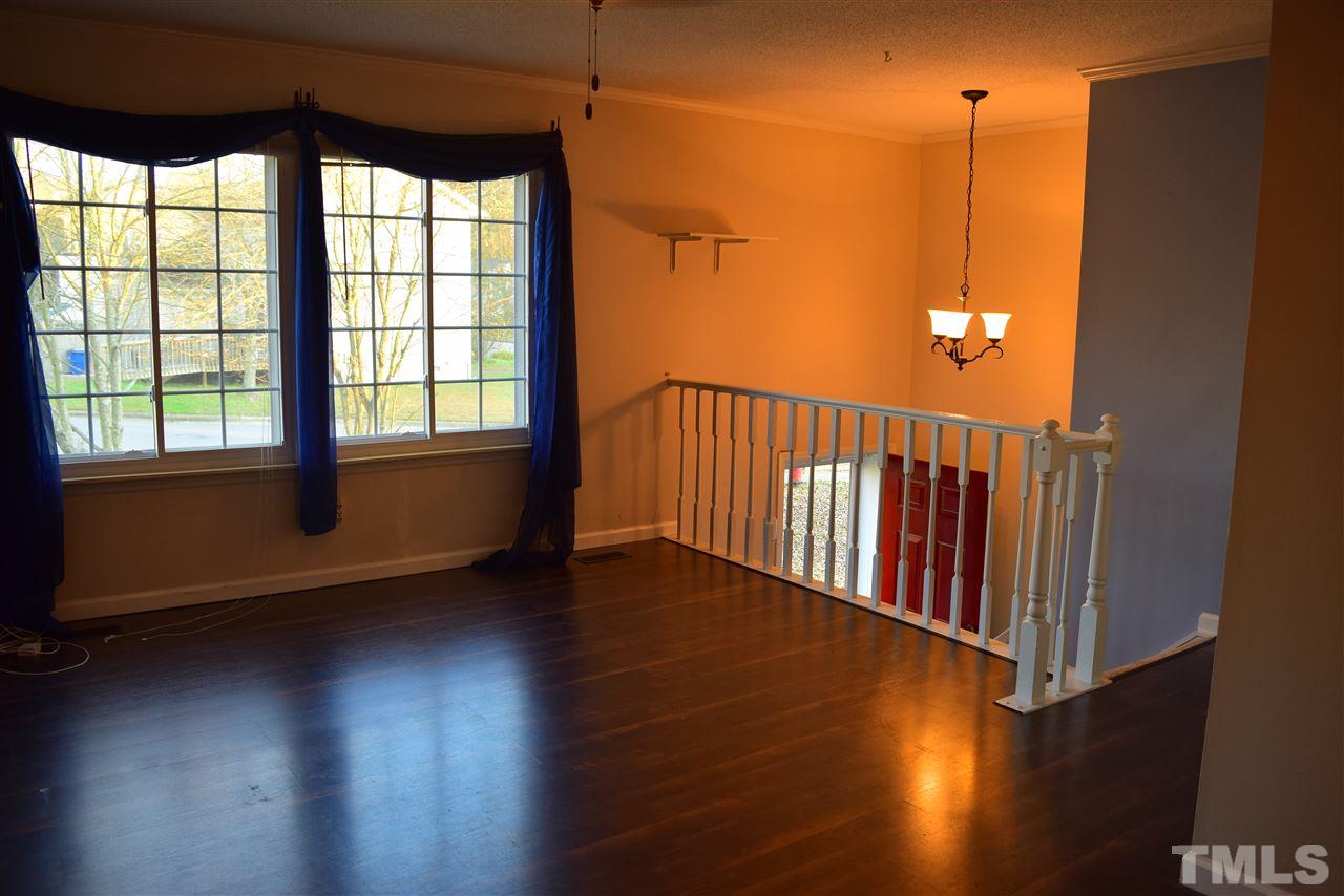 3103 Quinley Place Raleigh, NC 27604 - Photo 11 of 18 a view of a room with wooden floor and windows