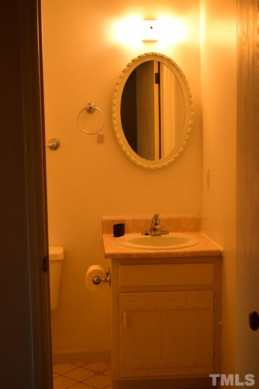3103 Quinley Place Raleigh, NC 27604 - Photo 15 of 18 a bathroom with a sink and a mirror