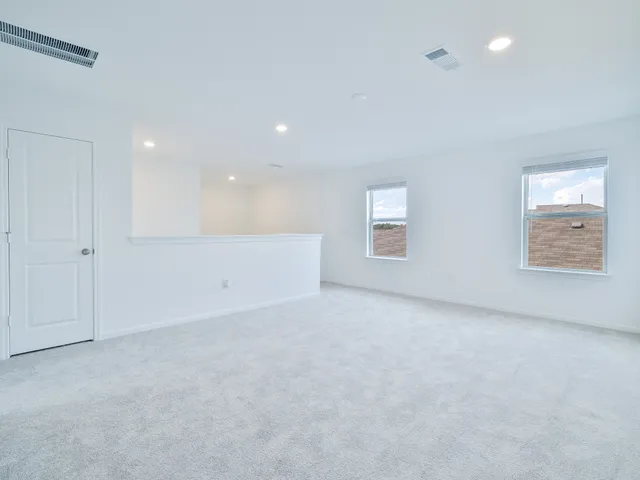 a view of an empty room and a window