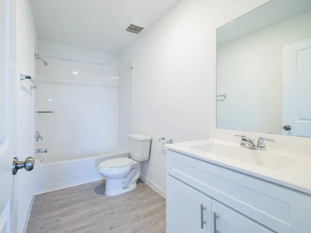 a view of a house with a yard and porch