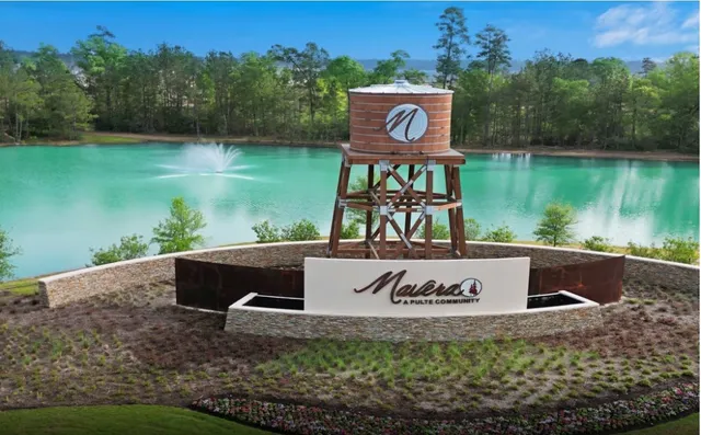 an aerial view of a house with outdoor space patio and lake view