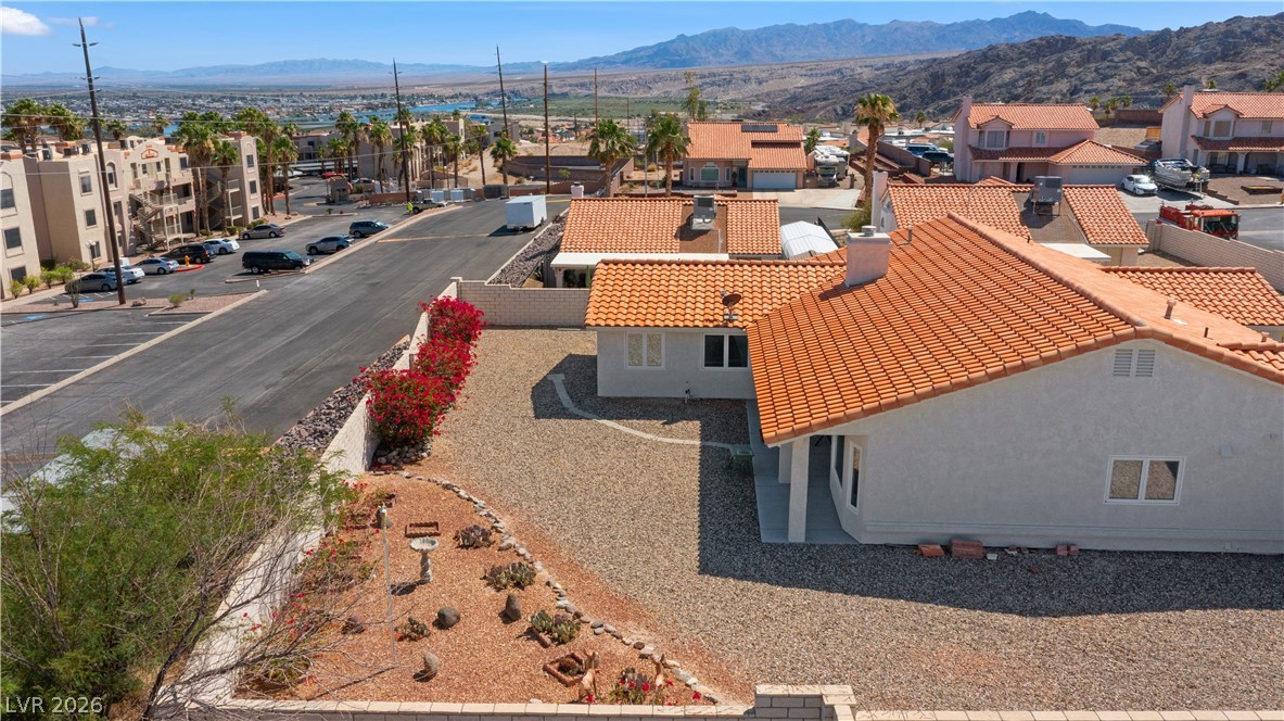 2055 Cholla Way Laughlin, NV 89029 - Photo 77 of 87 Terracotta roof tiles crown this residence, featuring a drought-tolerant landscape and a partial privacy wall.