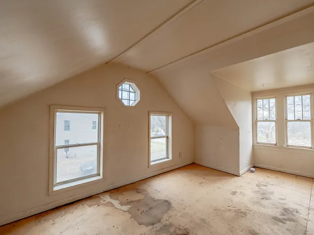 an empty room with windows and closet