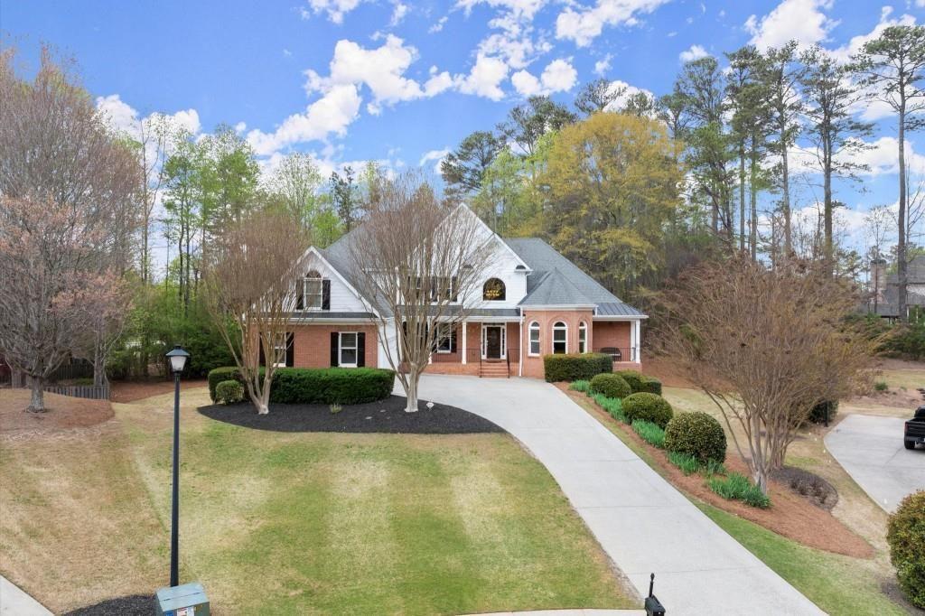a front view of house with yard and green space