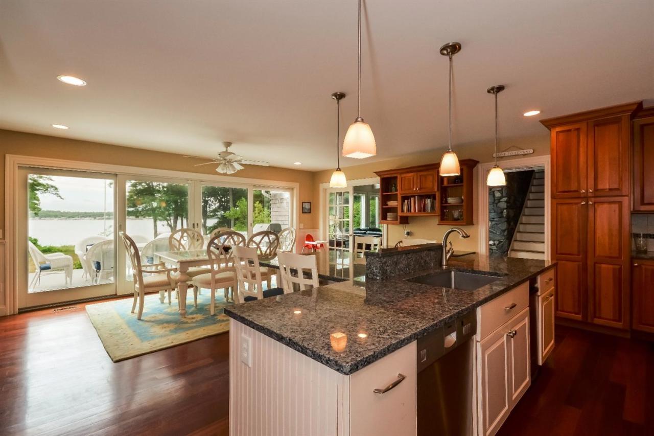 40 Catskill Road Buzzards Bay, MA 02532 - Photo 12 of 35 a kitchen with stainless steel appliances granite countertop a sink a stove and a wooden floors