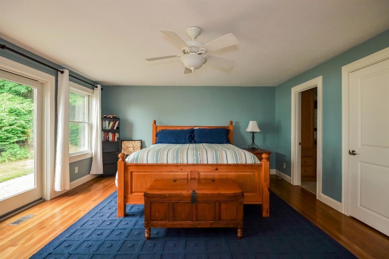 40 Catskill Road Buzzards Bay, MA 02532 - Photo 17 of 35 a bedroom with a bed and wooden floor