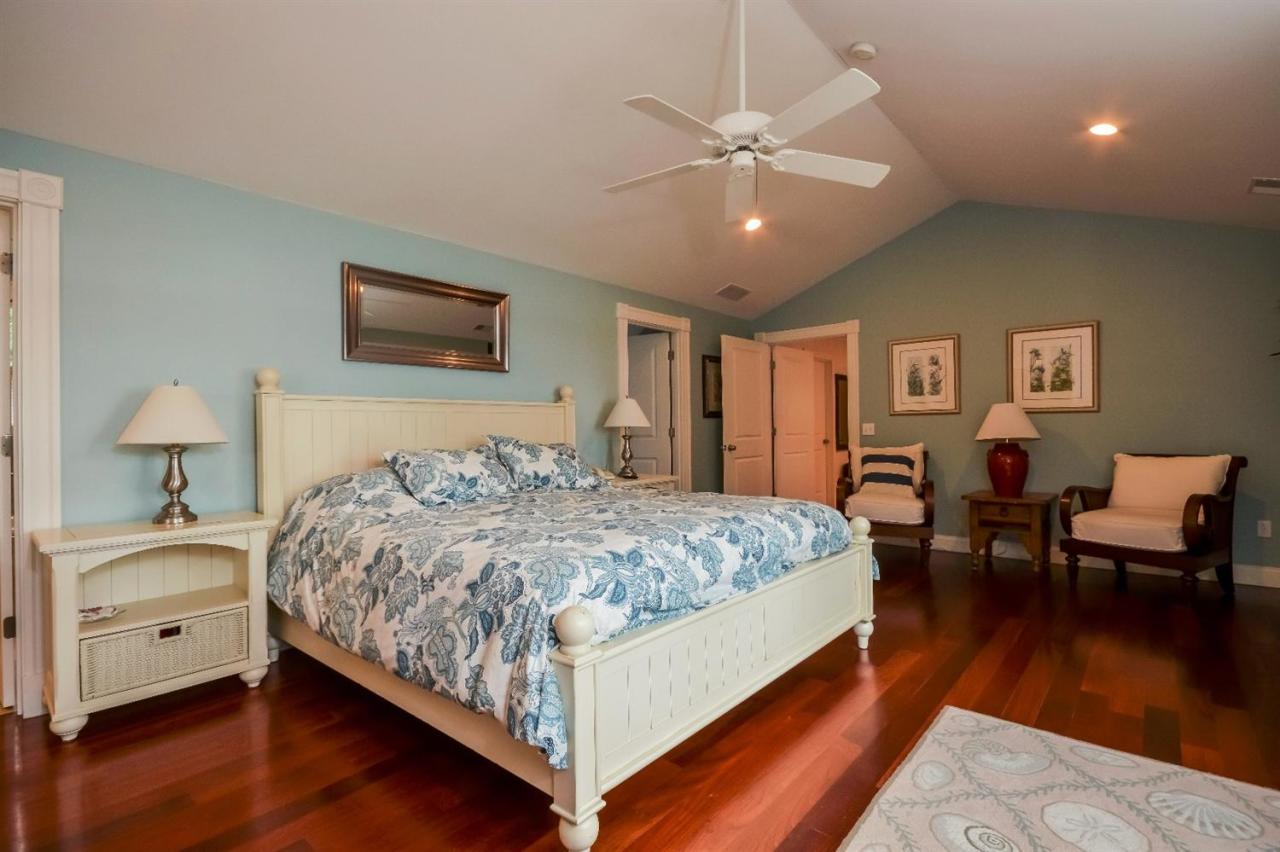 40 Catskill Road Buzzards Bay, MA 02532 - Photo 21 of 35 a bedroom with a large bed and a chandelier