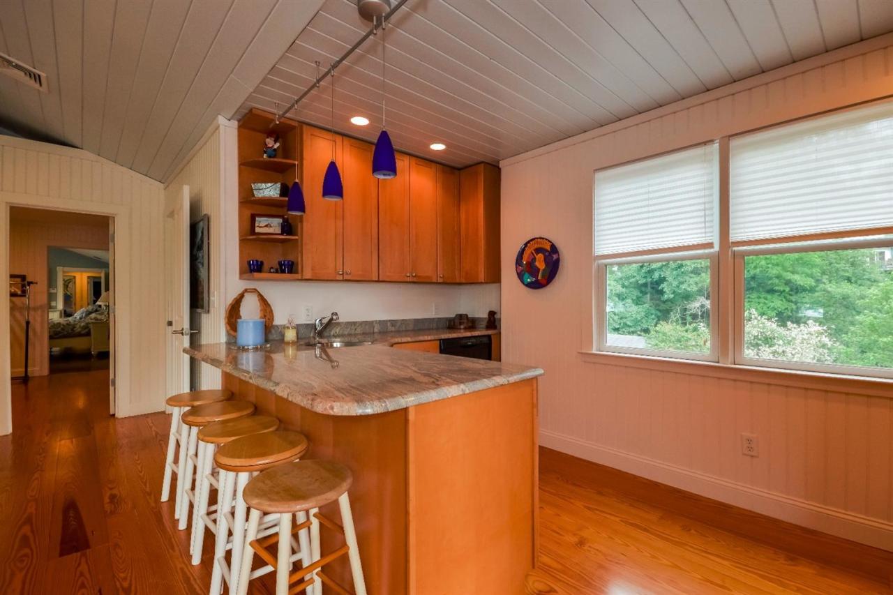 40 Catskill Road Buzzards Bay, MA 02532 - Photo 27 of 35 a kitchen with a sink a stove cabinets and a wooden floor