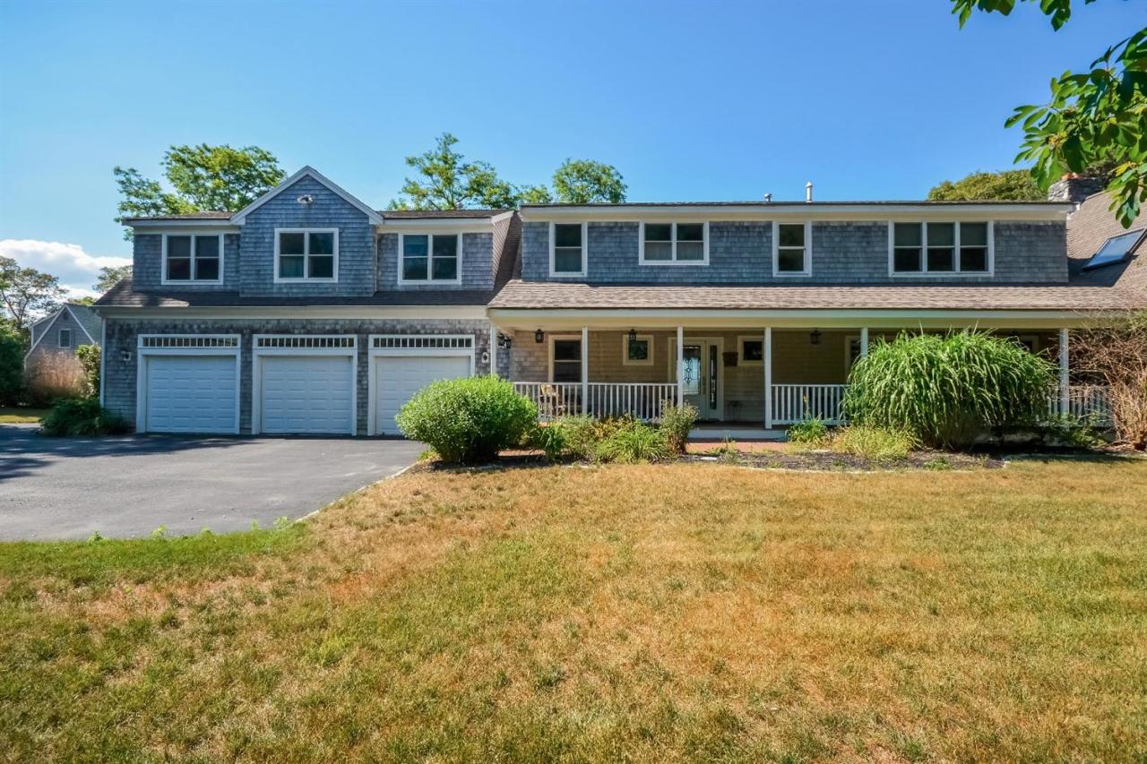 40 Catskill Road Buzzards Bay, MA 02532 - Photo 28 of 35 a front view of a house with a yard and garage