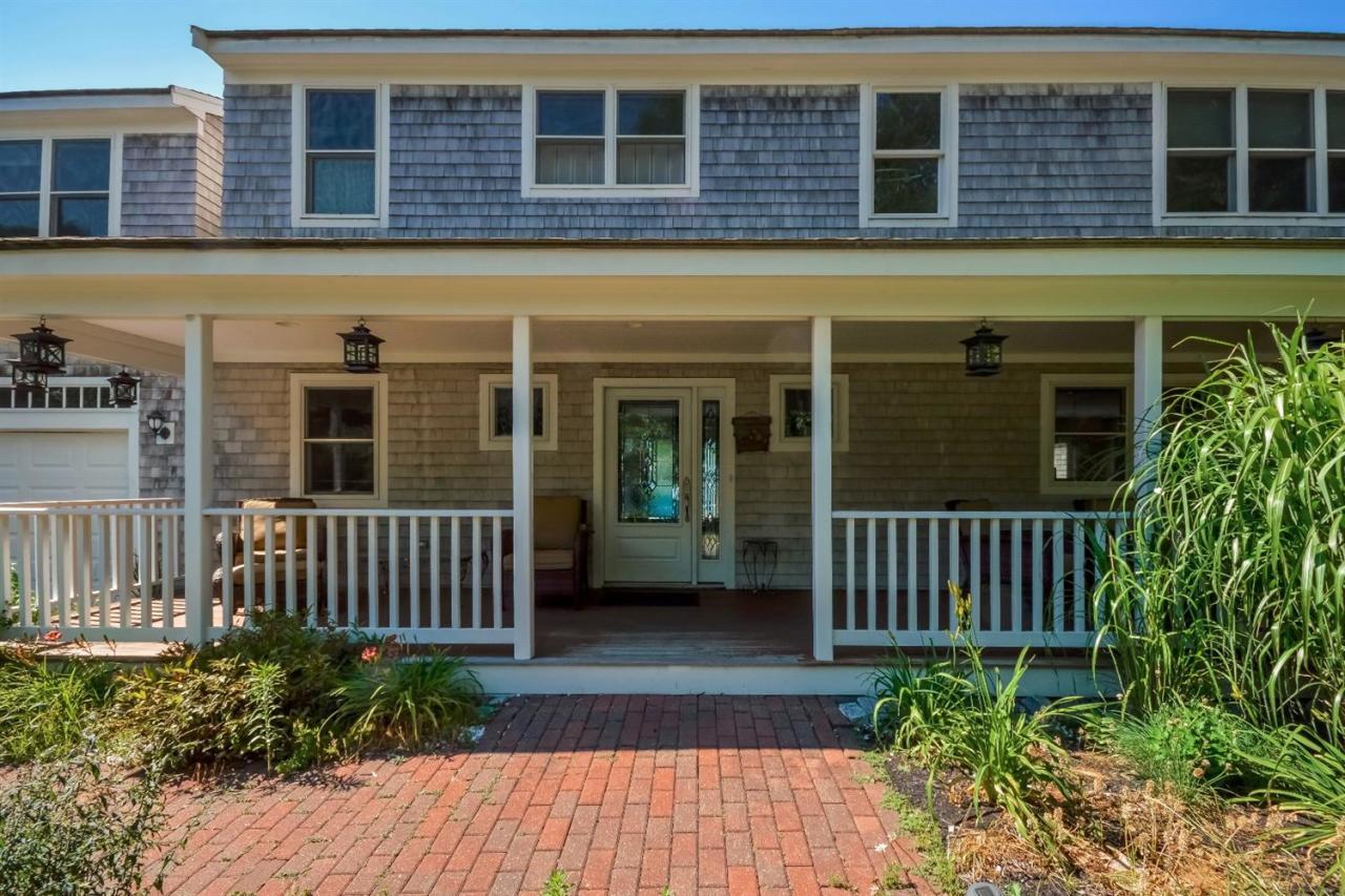 40 Catskill Road Buzzards Bay, MA 02532 - Photo 8 of 35 a view of a brick house with plants and bench