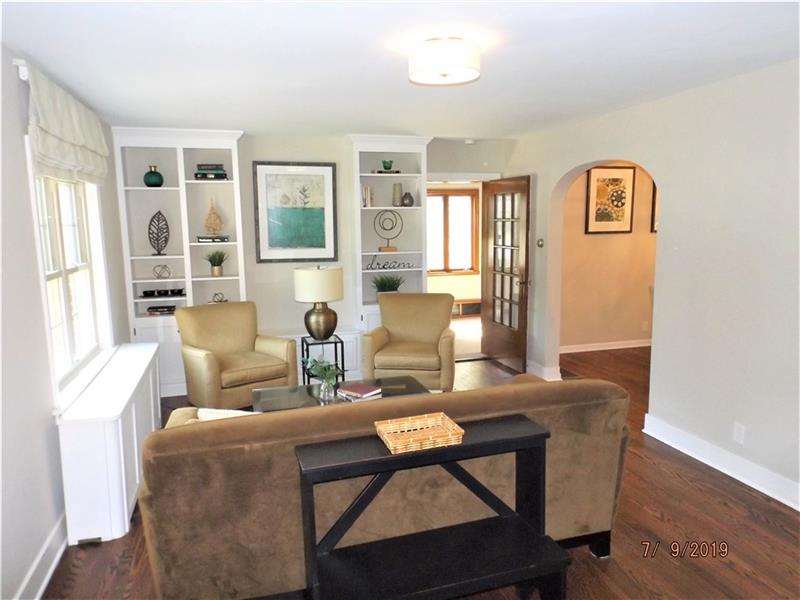 115 Spring Grove Road Penn Hills, PA 15235 - Photo 2 of 25 Living Room with Built in Shelves and Beautiful Hardwood Floors.