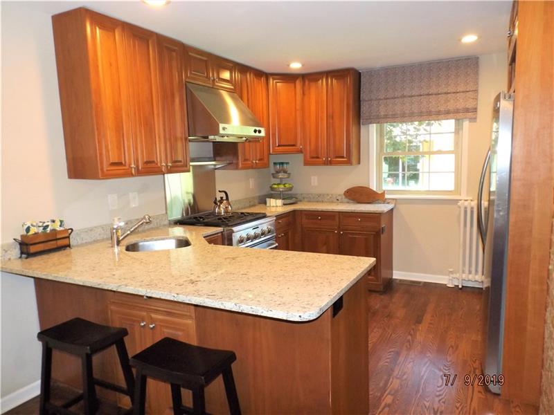 115 Spring Grove Road Penn Hills, PA 15235 - Photo 3 of 25 Updated Kitchen with Granite Counters, Refinished Hardwood Floors. Breakfast Bar and Stainless Appliances.