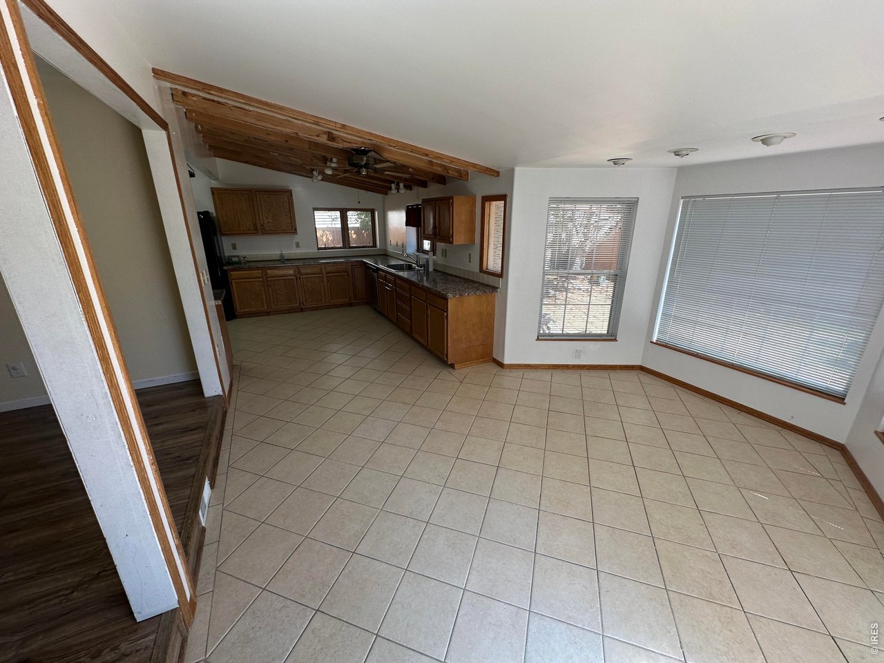 268 Fifth Street Firestone, CO 80520 - Photo 6 of 25 a view of an empty room with kitchen and window