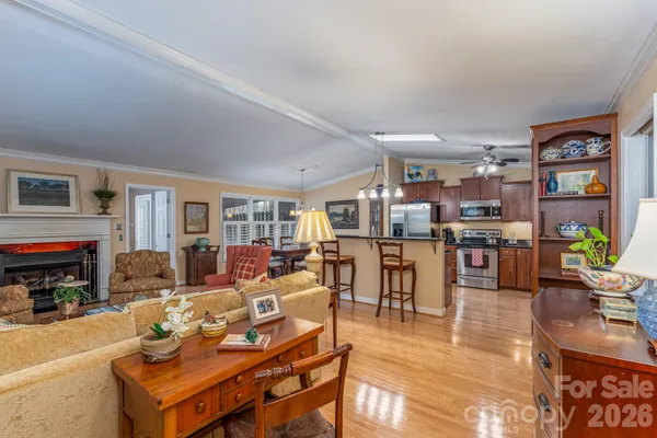 a living room with lots of furniture and kitchen view