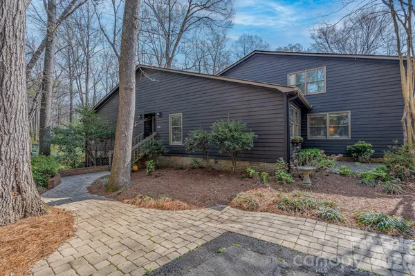 a view of a house with a yard and hanging chair