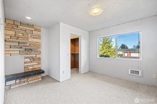 an empty room with windows and closet