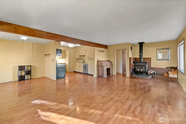 a view of a livingroom with furniture and an empty room