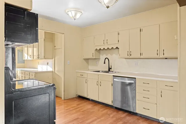 a kitchen with cabinets a sink and appliances
