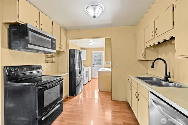 a kitchen with stainless steel appliances granite countertop a stove and a refrigerator
