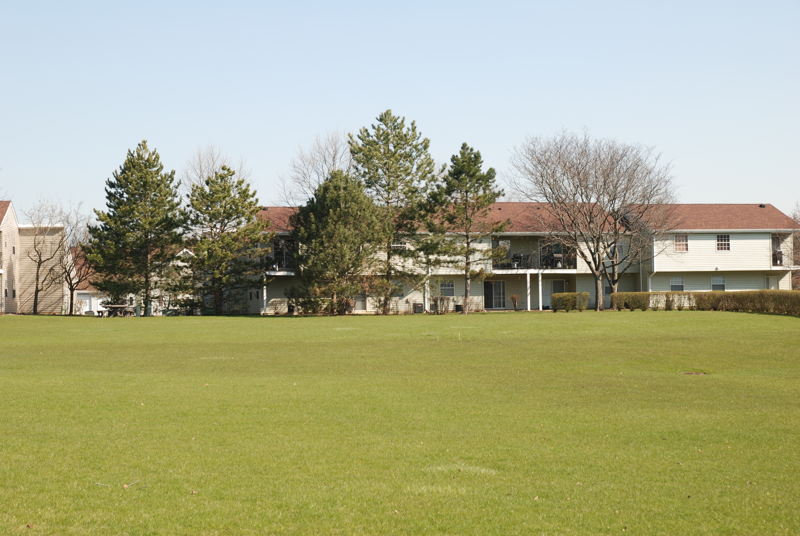 59 Gant Circle, Unit F Streamwood, IL 60107 - Photo 14 of 18 a front view of a building with large trees