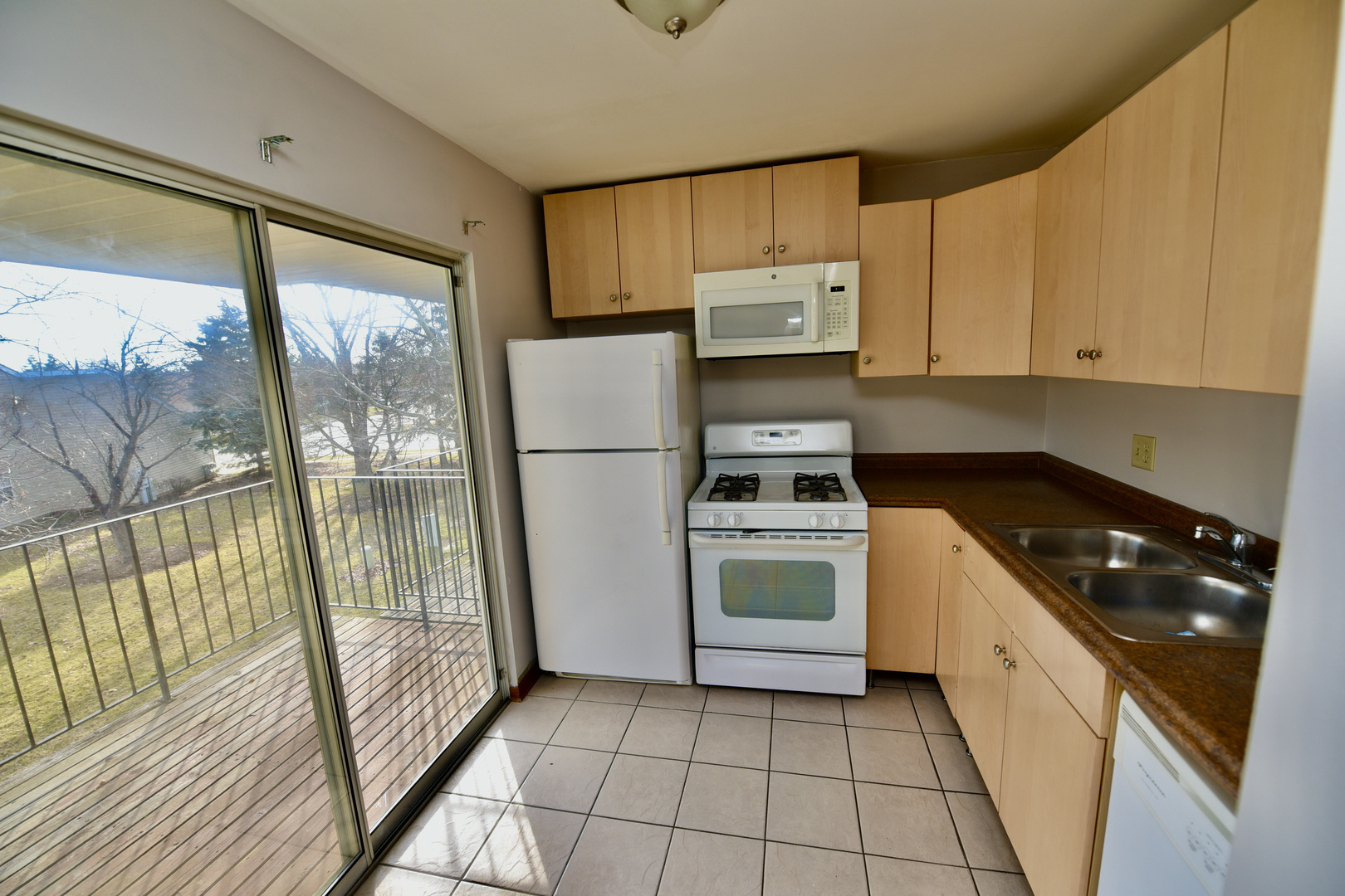 59 Gant Circle, Unit F Streamwood, IL 60107 - Photo 3 of 18 a kitchen with a refrigerator a stove a sink and cabinets