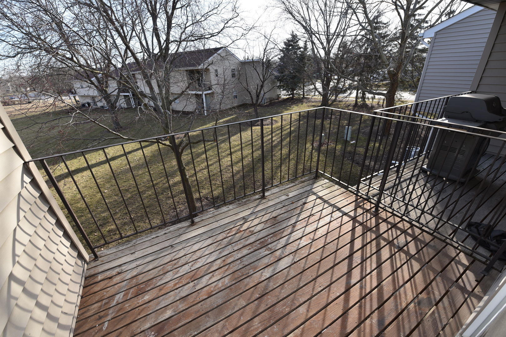 59 Gant Circle, Unit F Streamwood, IL 60107 - Photo 4 of 18 a view of balcony with wooden floor and trees