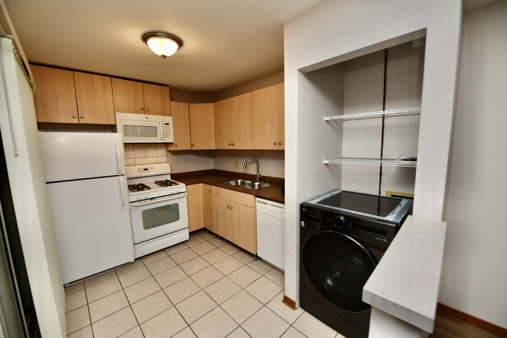 59 Gant Circle, Unit F Streamwood, IL 60107 - Photo 6 of 18 a kitchen with a refrigerator sink and cabinets
