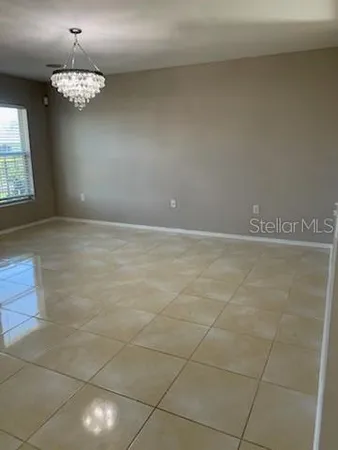 a large kitchen with granite countertop a large stove a sink a counter space and a window