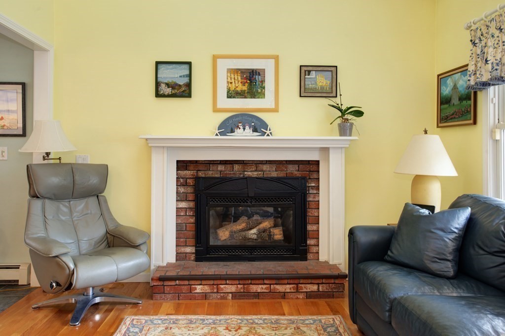55 Pond Circle Mashpee, MA 02649 - Photo 11 of 40 a living room with furniture and a fireplace