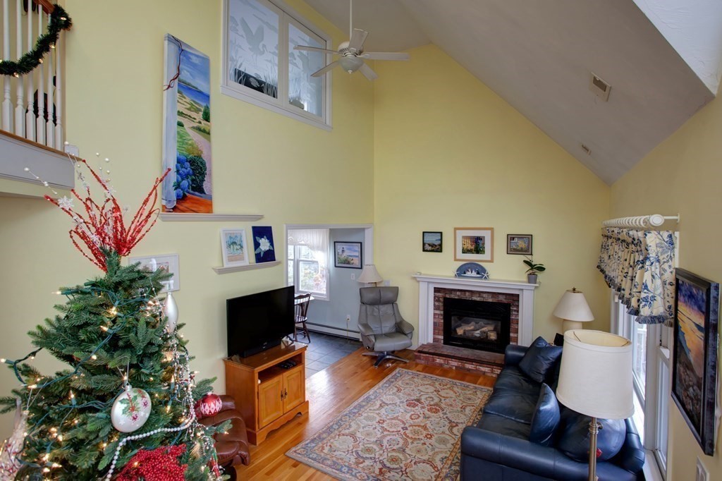 55 Pond Circle Mashpee, MA 02649 - Photo 12 of 40 a living room with furniture and a fireplace
