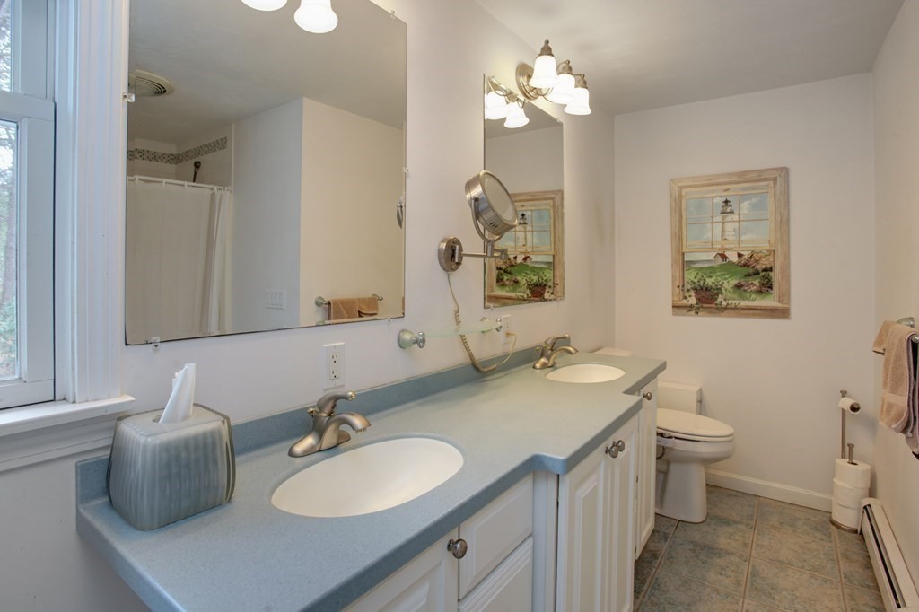 55 Pond Circle Mashpee, MA 02649 - Photo 14 of 40 a bathroom with a sink double vanity and a toilet