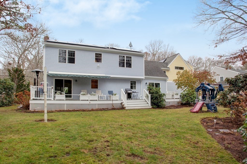 55 Pond Circle Mashpee, MA 02649 - Photo 27 of 40 a front view of a house with garden