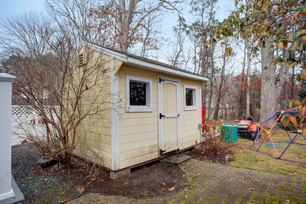 55 Pond Circle Mashpee, MA 02649 - Photo 31 of 40 a view of a small house with a yard