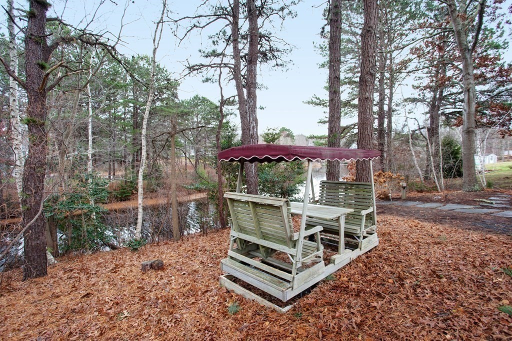55 Pond Circle Mashpee, MA 02649 - Photo 32 of 40 a view of a small house with backyard