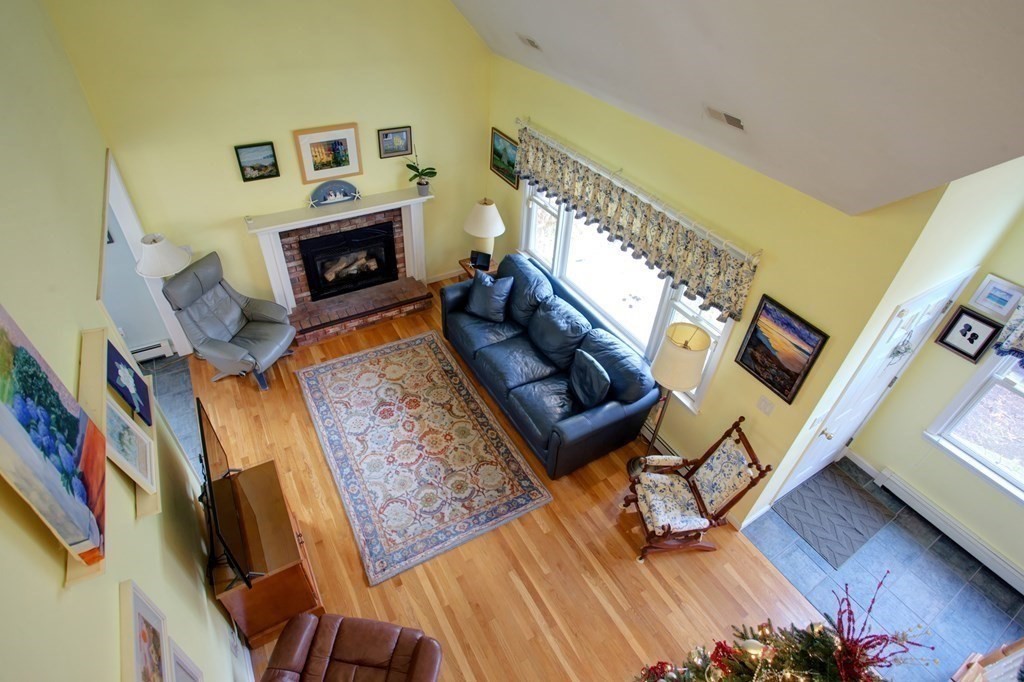 55 Pond Circle Mashpee, MA 02649 - Photo 9 of 40 a living room with furniture and a fireplace