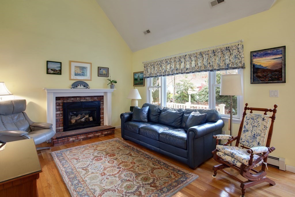 55 Pond Circle Mashpee, MA 02649 - Photo 10 of 40 a living room with furniture and a fireplace
