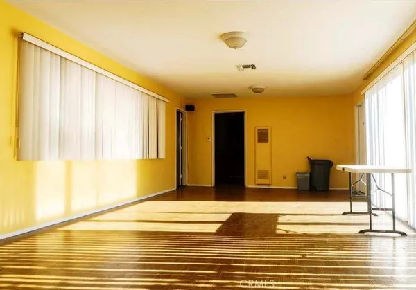a view of a living room with furniture and floor to ceiling window