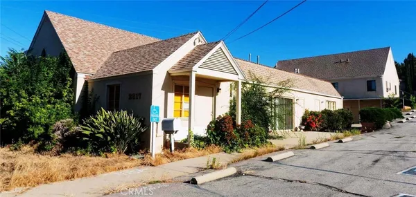a view of a house with palm trees