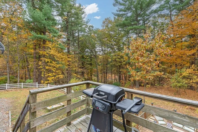 a view of a balcony with wooden floor and fence