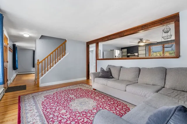 a living room with furniture and stairs