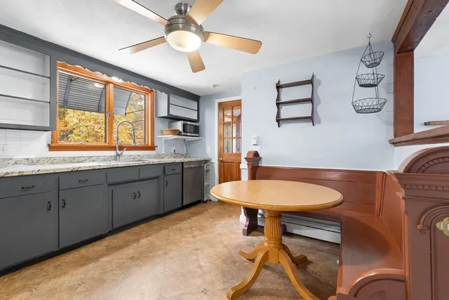 a room with a chandelier furniture a window and a sink