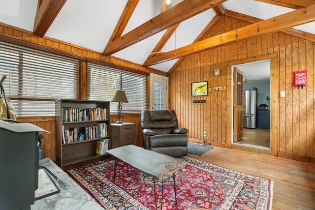 a living room with furniture and a book shelf