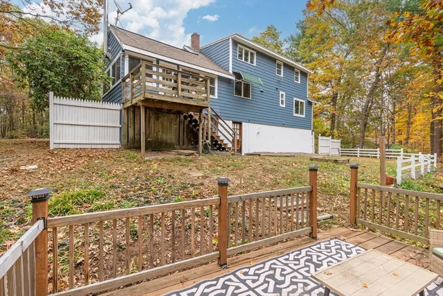 a view of a house with wooden fence