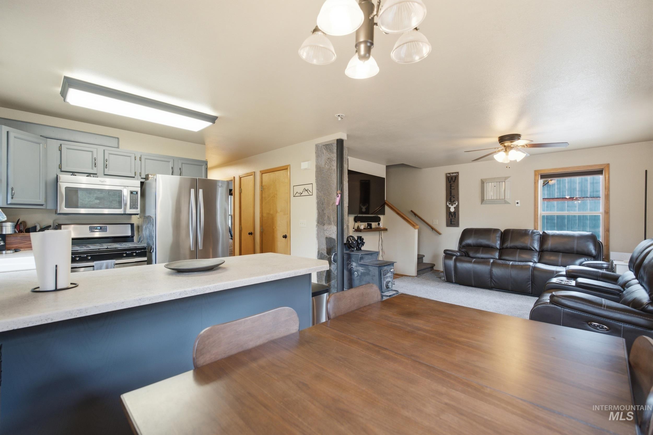 3980 North Pine-Featherville Road Mountain Home, ID 83647 - Photo 14 of 35 Kitchen island with light-toned countertop and blue-painted base